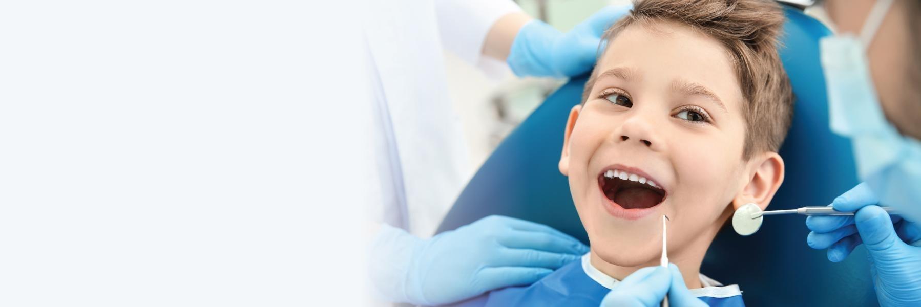 Child smiling at the dentist office in Glenmont, NY